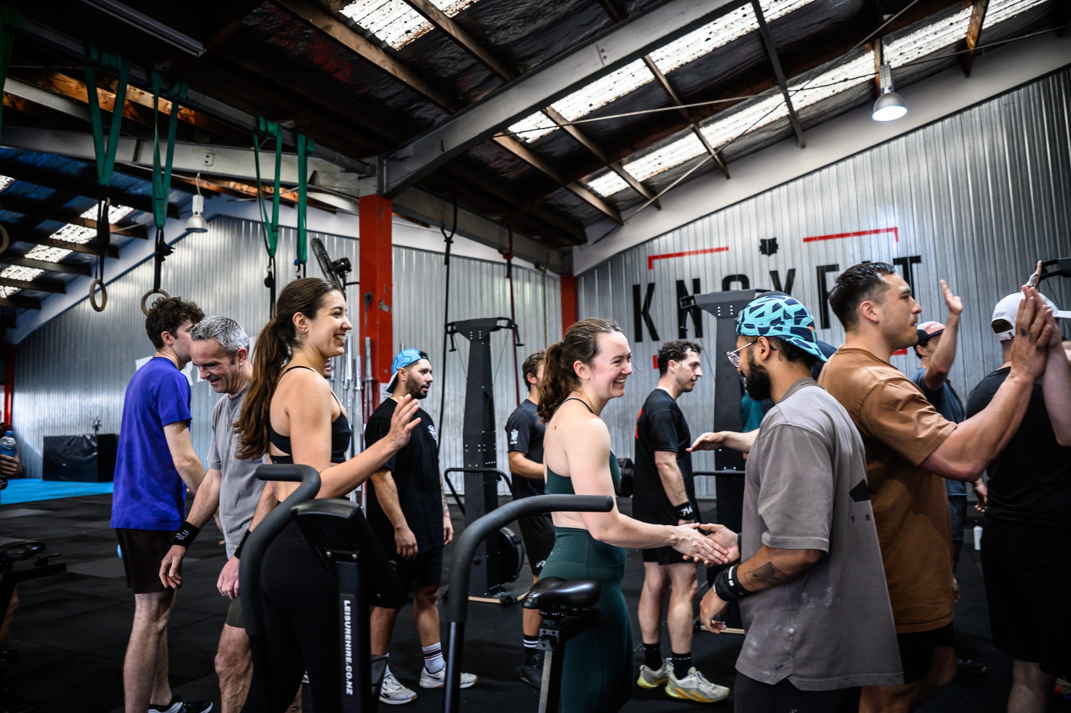 KnoxFit members high-fiving and celebrating together after a session